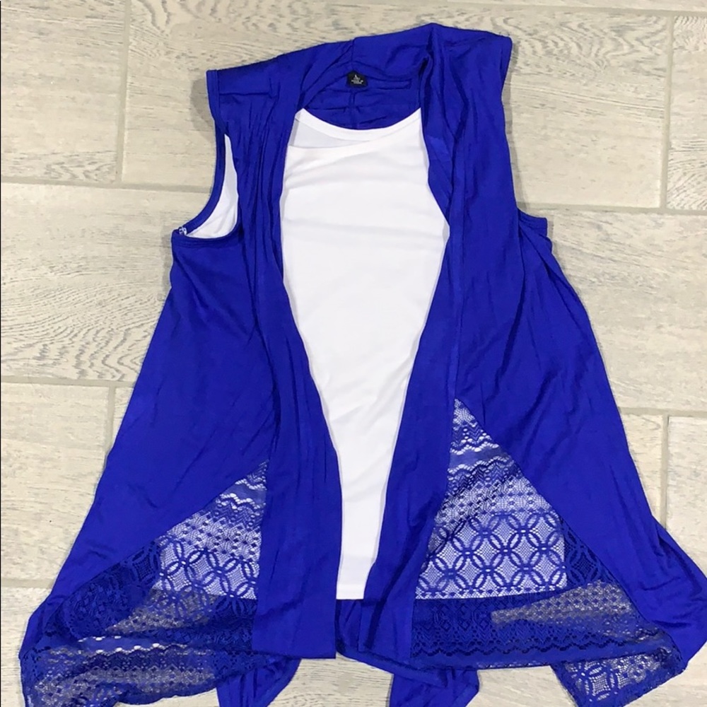 Sleeveless blue cardigan bound to white tank top